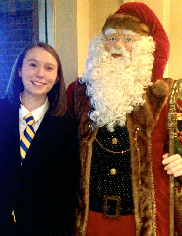 Jillian stands with a robotic Santa Claus on a We the People trip