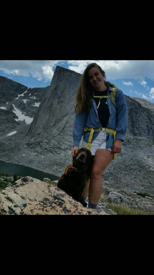 Bensel stands for a photo in the mountains with her dog. (Photo courtesy Kris Korfanta)