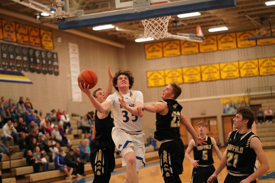 Junior Sam Lecholat drives to the basket against Buffalo defenders.