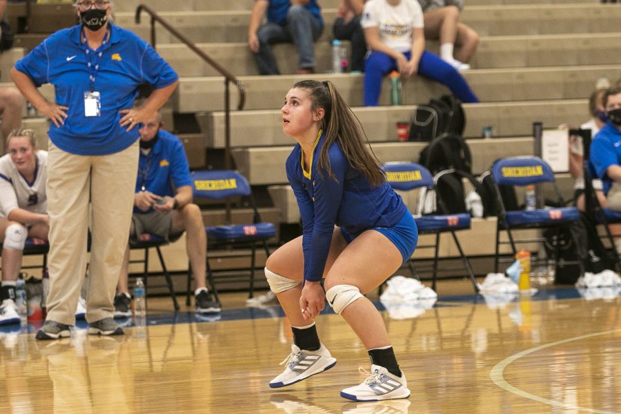 Addy Bolton, a senior liber for the Sheridan volleyball team, gets ready for the opposing team to serve during a home game. 